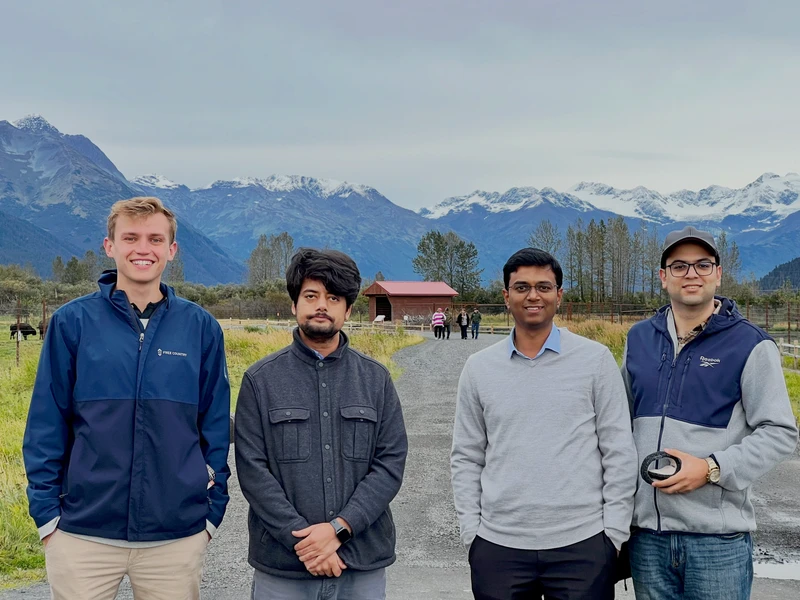 Sharan Srinivas and students in Alaska with mountains in the background.