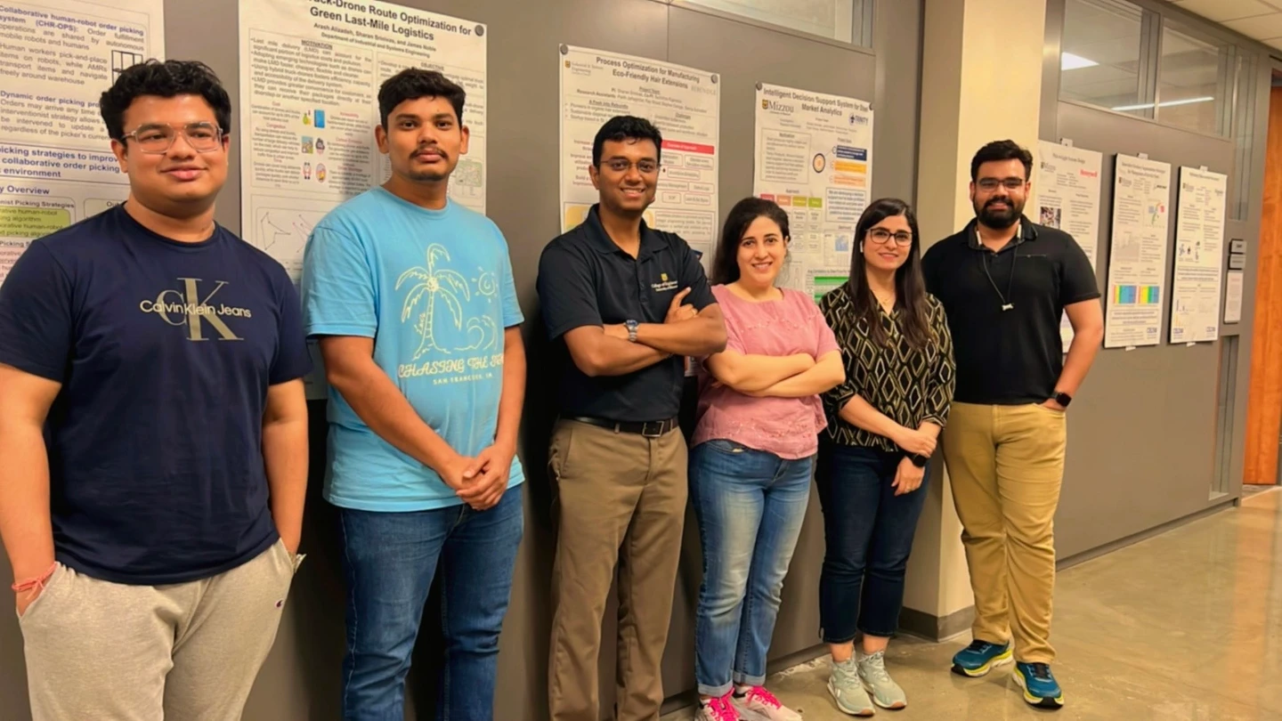 OptiDec researchers with project posters in the Industrial & Systems Engineering research space.