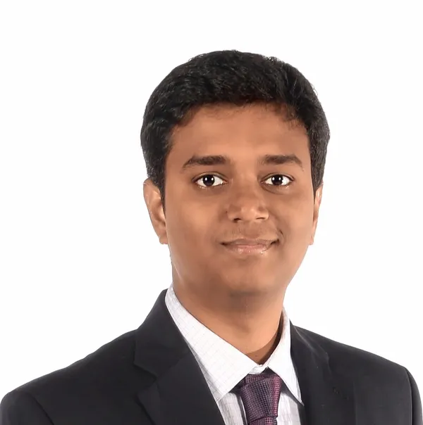 Formal portrait of Sharan Srinivas in a suit
