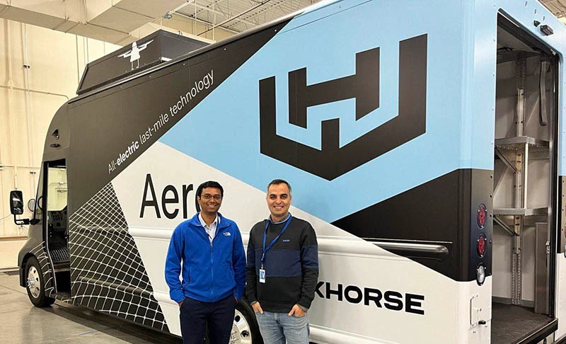 Sharan Srinivas and a collaborator beside a Workhorse Aero delivery vehicle