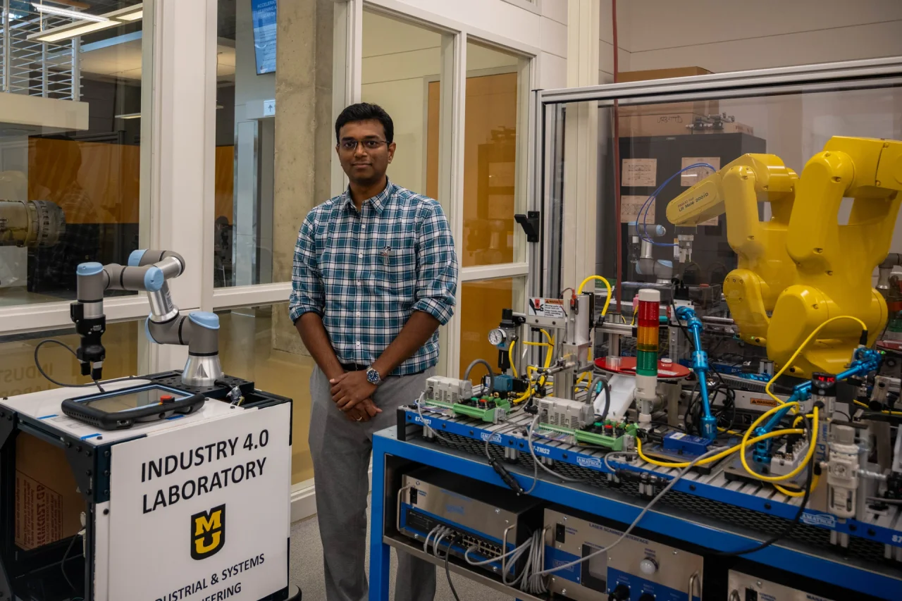 Sharan Srinivas in the Industry 4.0 laboratory, with robotic arms and manufacturing equipment