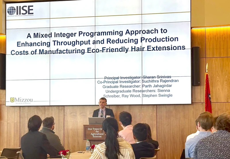 Ray Wood presenting optimization research on sustainable hair-extension manufacturing at an IISE conference.